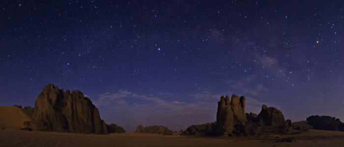 Rising above eroded sandstone cliffs in Tassili National Park, in the heart of the Sahara desert in southern Algeria the celestial menagerie of constellations includes Draco the Dragon, Cygnus the Swan, Aquila the Eagle, and Scorpius the Scorpion. Babak Tafreshi/Dreamview.net